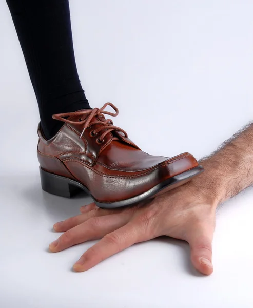 Zapato aplastando una mano sobre blanco — Foto de Stock