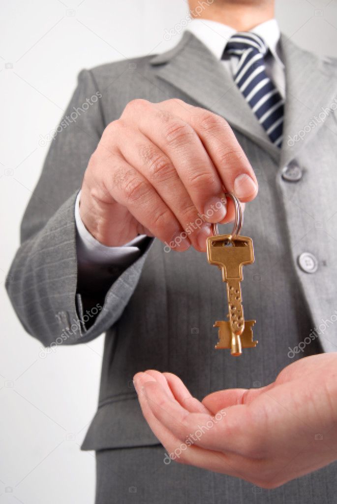 Businessman handing a key