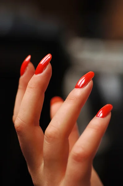 Vrouwelijke hand met rode nagellak — Stockfoto
