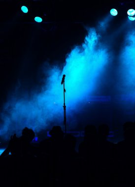 Empty blue stage with microphone clipart