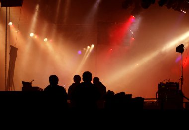 Silhouette of stage-crew at concert clipart