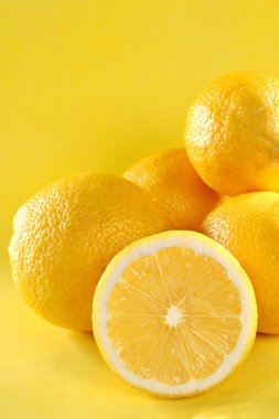 Group of lemon on yellow background clipart