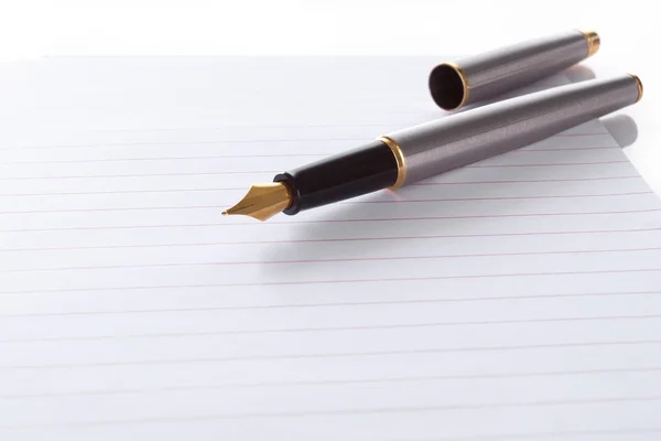 Fountain pen lying on page in a spiral b — Stock Photo, Image