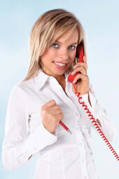 Young blond girl talking on a telephone — Stock Photo, Image