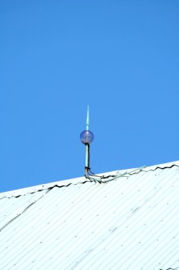 Lightning rod on top of a barn clipart