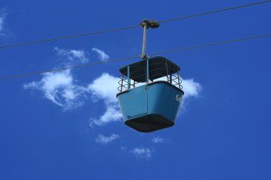 Gondola lift car against blue sky clipart