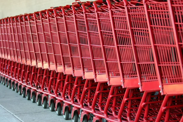 Row of red metal shopping carts — Stock Photo, Image