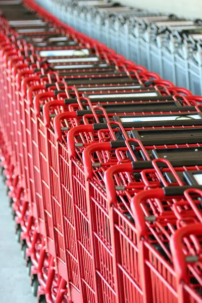 Row of red metal shopping carts — Stock Photo, Image