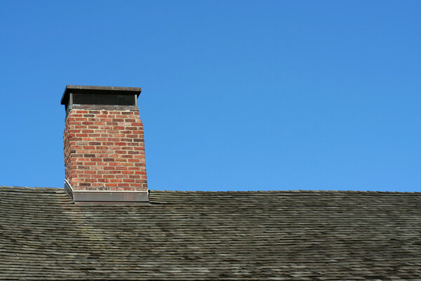 Old roof and chimney with blue sky