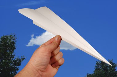 Paper airplane on blue sky clipart