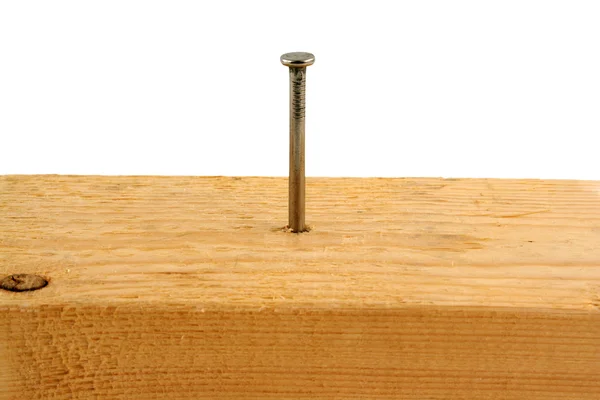 Ten penny nail in a peice of wood — Stock Photo, Image