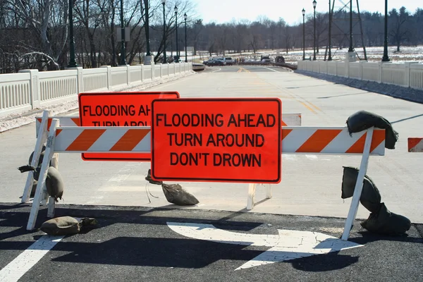 stock image Flooded roadway sign on a bridge