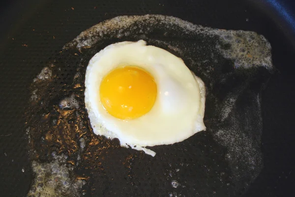 stock image Sunnyside up egg frying in a pan