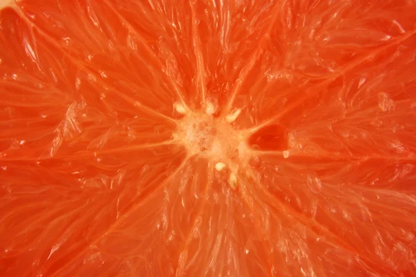 Pink grapefruit half background texture — Stock Photo, Image