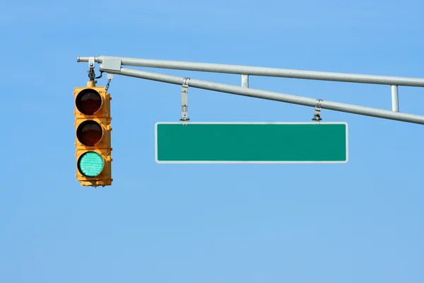 Green traffic signal light with sign — Stock Photo, Image