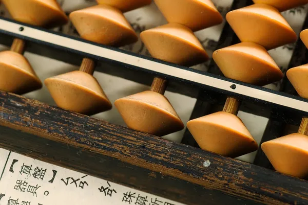 Abacus lay on a paper — Stock Photo, Image