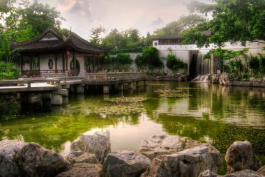 Chinese style house near the pond clipart