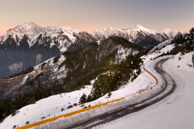 Mountain night with snow and ice on road clipart