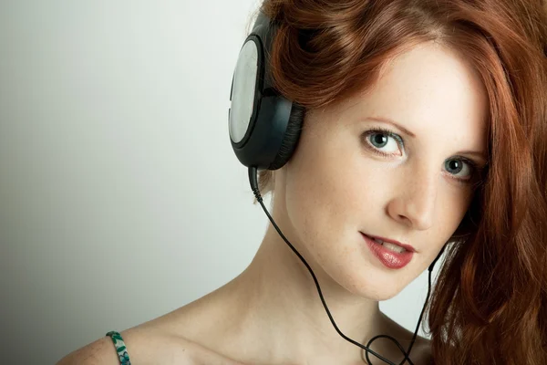 stock image The young girl with headphones