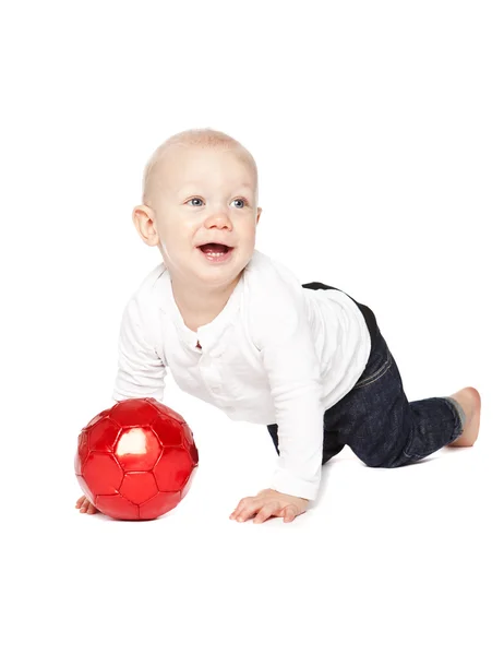 Gutt som leker med en rød ball – stockfoto