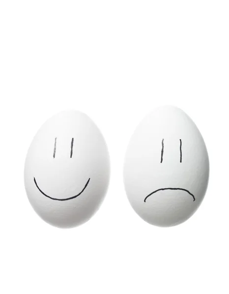 Sad face and a happy face painted on whi — Stock Photo, Image