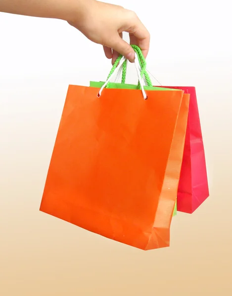 Female hand holding giftbags — Stock Photo, Image