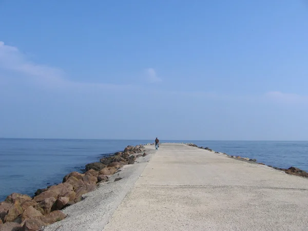 stock image Man walking on the pier