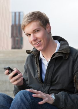 Young guy with cellphone clipart