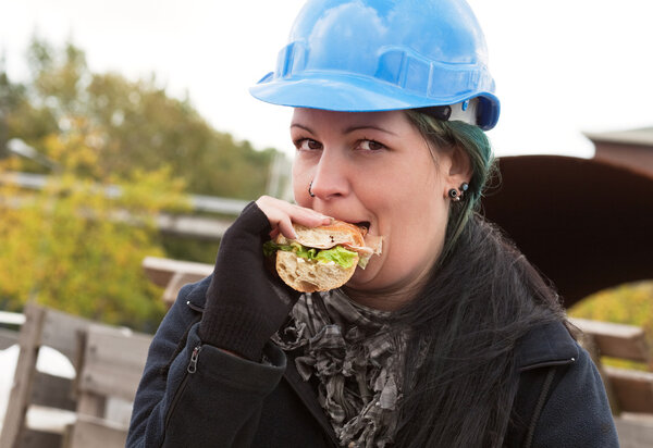 Female worker eating sandwich
