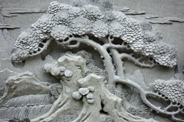 Chinese Feng Shui pine tree carving. clipart