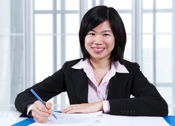 Азиатка, работающая в офисе — стоковое фото