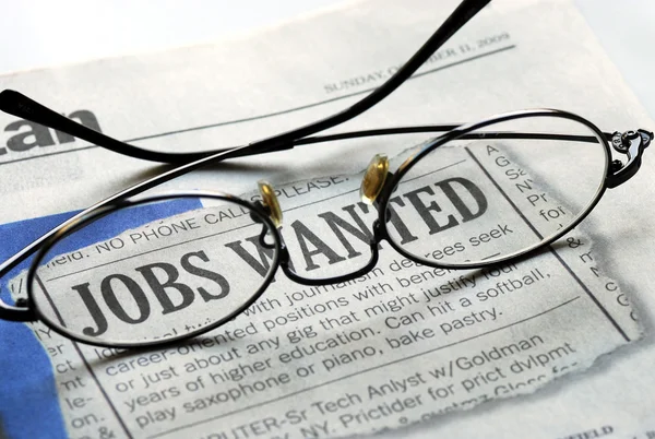 Searching for a job from a newspaper — Stock Photo, Image