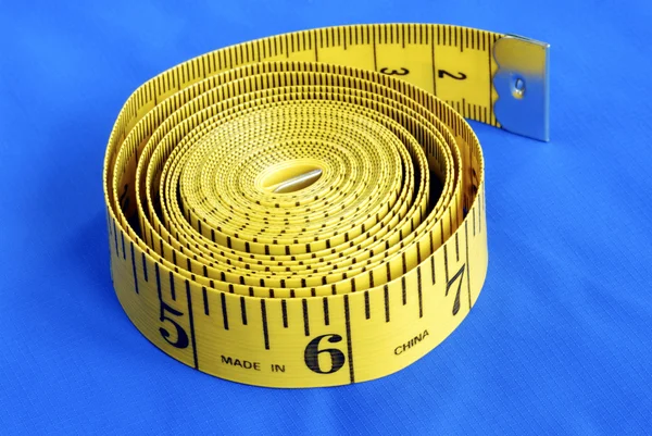 Una cinta métrica en espiral Imagen de stock
