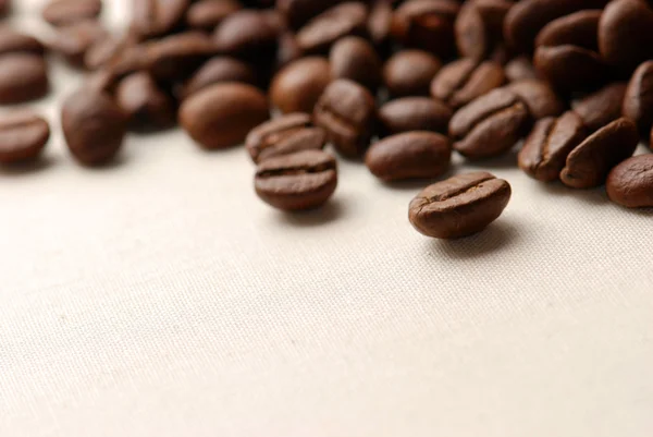 Coffee grains on a rough sacking — Stock Photo, Image