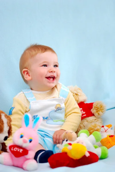 Baby boy on blue smiling — Stock Photo, Image