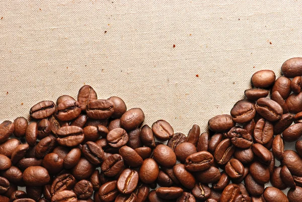 Granos de café en un saqueo áspero —  Fotos de Stock