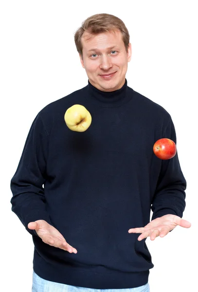 Hombre en tela oscura malabares manzana — Foto de Stock