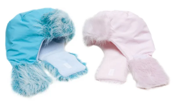 Dos sombreros de piel de bebé de invierno, rosa y azul —  Fotos de Stock