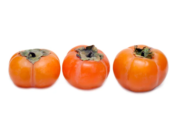列に 3 つの柿 — ストック写真
