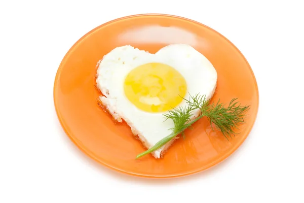 Fried egg in form heart on plate — Stock Photo, Image