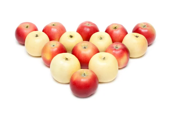 Red and yellow apple put by triangle — Stock Photo, Image