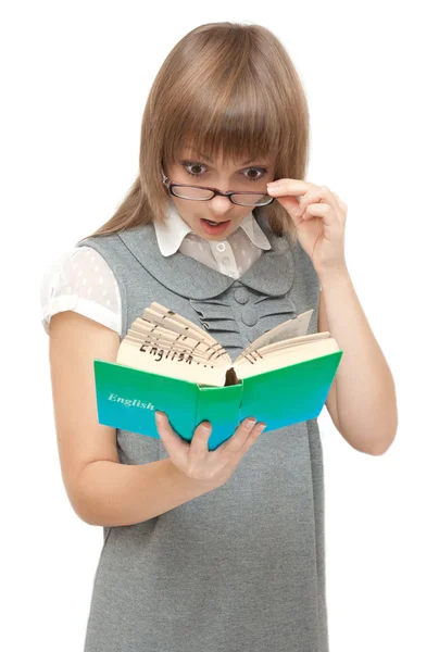 Young girl reads english and wonders — Stock Photo, Image