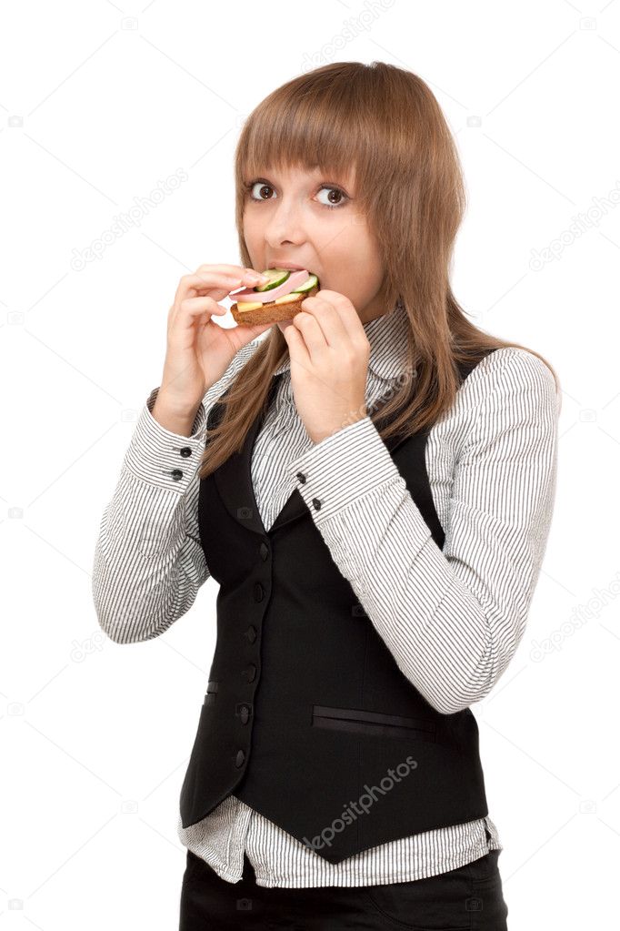 Young girl eats sandwich