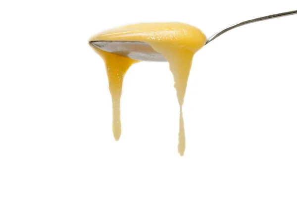Iron spoon flowing down honey — Stock Photo, Image