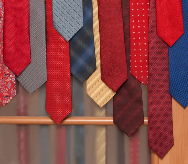 Male ties hung on door — Stock Photo, Image