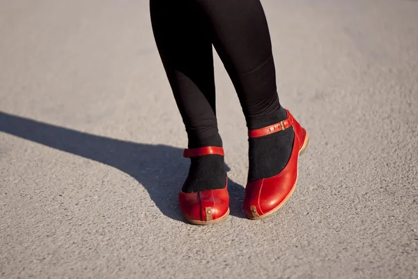 bacakları ve kaldırım üzerinde kırmızı ayakkabılar