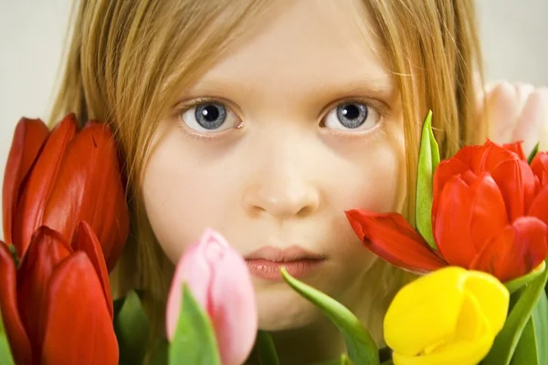 Girl and tulips — Stock Photo, Image