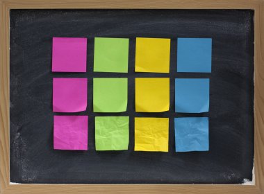 Blank sticky notes on blackboard