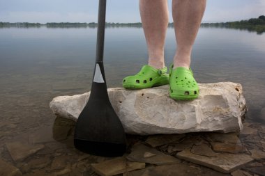 Green clogs and canoe paddle clipart