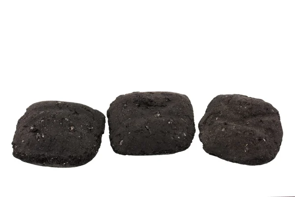 Три угольных брикета — стоковое фото
